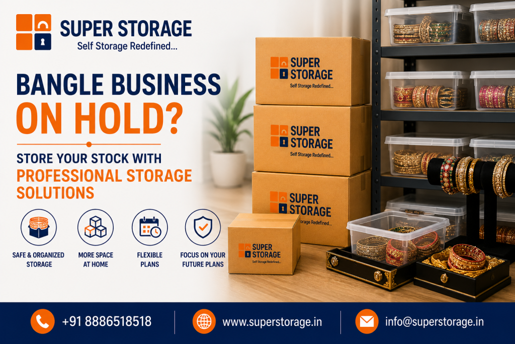 A promotional banner for Super Storage targeting boutique and jewelry owners, depicting a collection of traditional bangles displayed in clear plastic containers, decorative trays, and display stands alongside stacked Super Storage cardboard boxes on metal shelving, accompanied by the headline "Bangle Business On Hold? Store Your Stock With Professional Storage Solutions", service icons for "Safe & Organized Storage", "More Space At Home", "Flexible Plans", and "Focus On Your Future Plans", with contact details at the bottom.